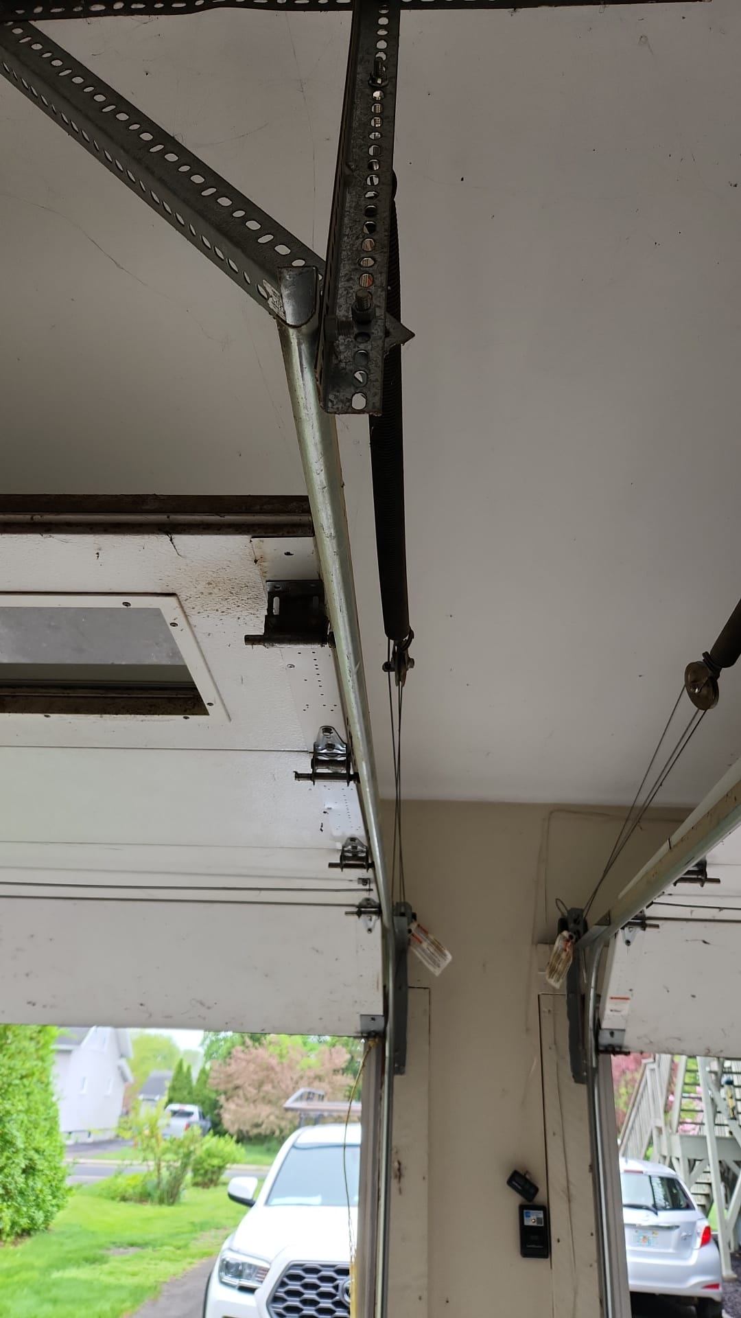 Garage door mechanism and tracks showing professional installation and repair services