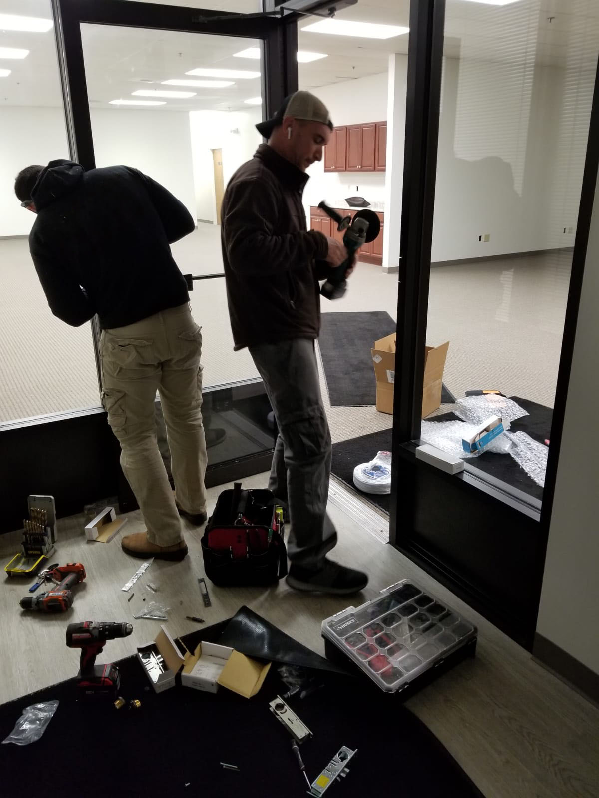 SLK Services team working on commercial door installation