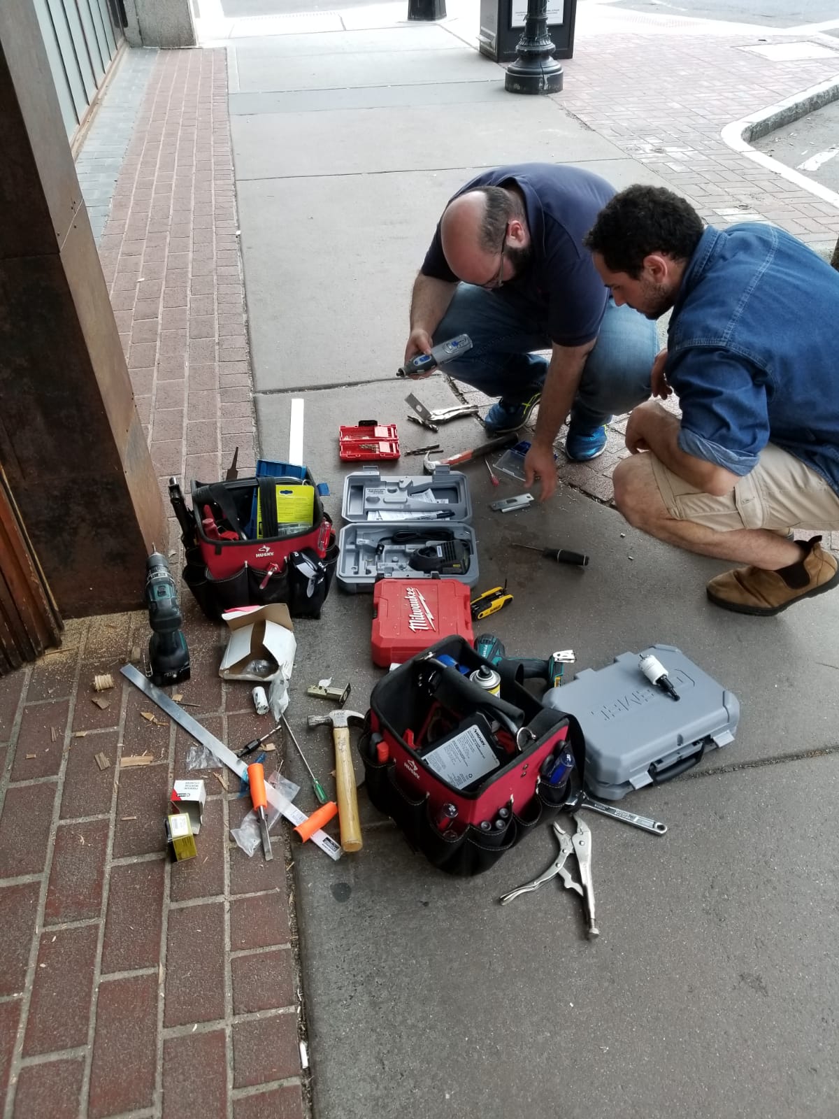 SLK Services team performing outdoor repair work