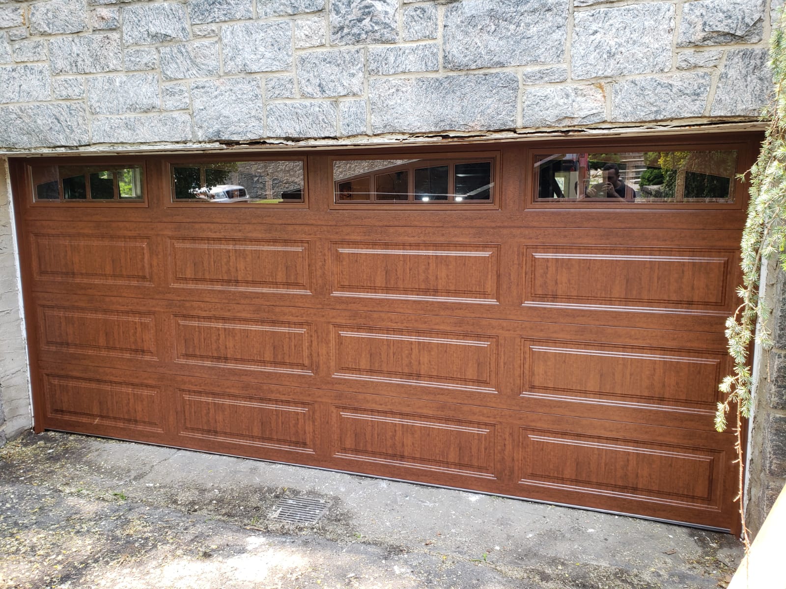 Beautiful wooden garage door with decorative glass windows installed by SLK Services